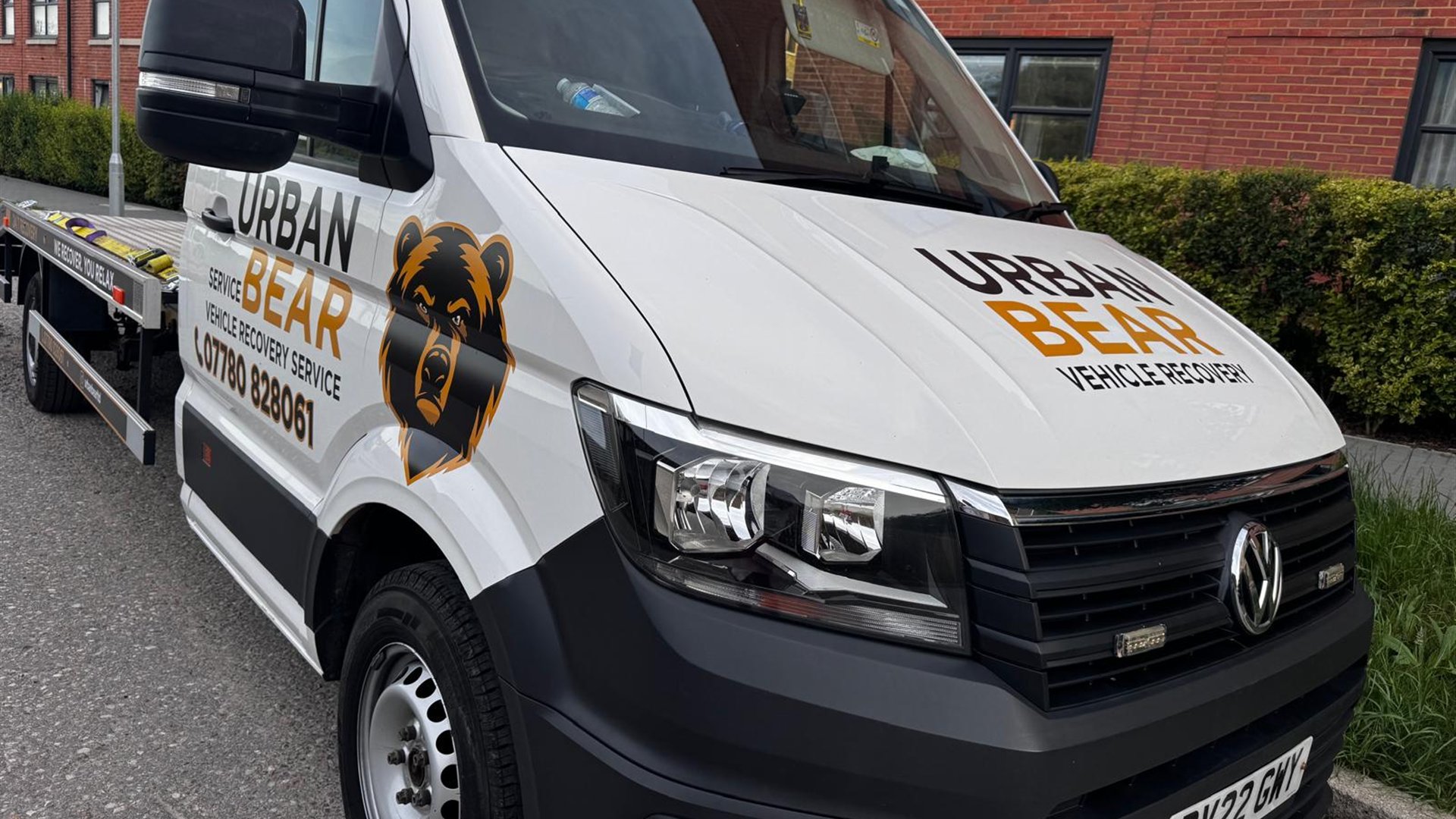 Urban Bear Recovery's branded flatbed recovery truck parked and ready
